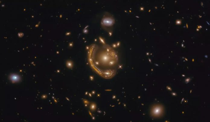 An image of a galaxy being smeared around a gravitational lens creating one of the most complete Einstein rings ever seen, as captured by the Hubble Space Telescope. (Image credit: ESA/Hubble & NASA, S. Jha Acknowledgement: L. Shatz)