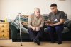 senior man with care worker at home
