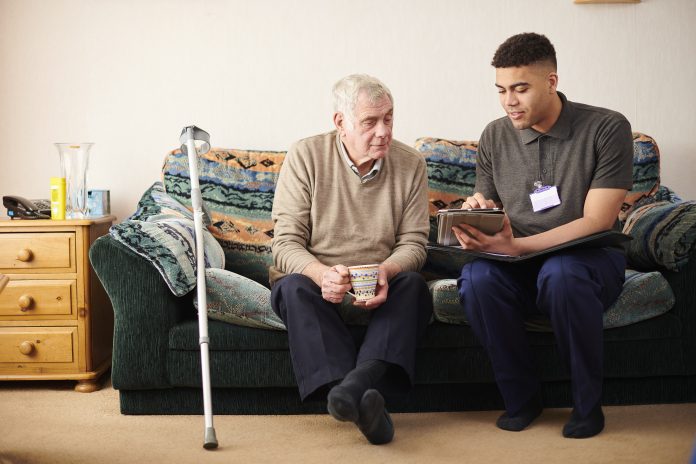 senior man with care worker at home