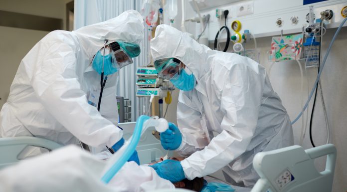 Healthcare workers intubating a COVID patient.