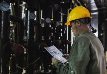 Engineer working on computer to maintain heating and cooling sistems