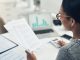 Closeup shot of an unrecognisable businesswoman calculating finances in an office