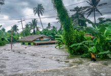 Rising water levels submerging a house as heavy monsoon rains cause major floods in Baco, Oriental Mindoro, Philippines on July 23, 2021.