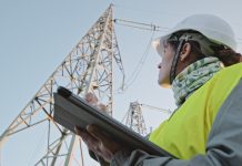 High voltage female engineer working on the field.