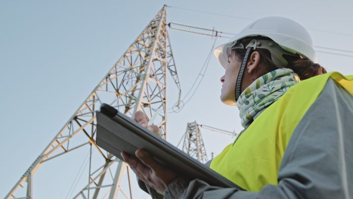 High voltage female engineer working on the field.