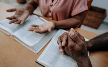 Couple praying together and studying religion