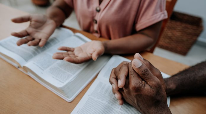 Couple praying together and studying religion