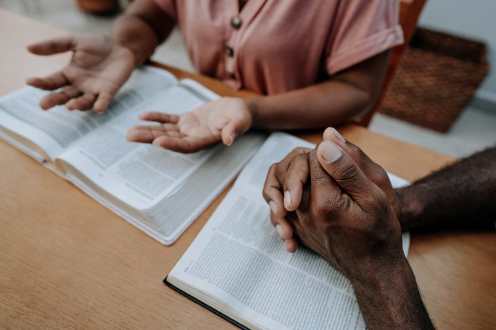 Couple praying together and studying religion