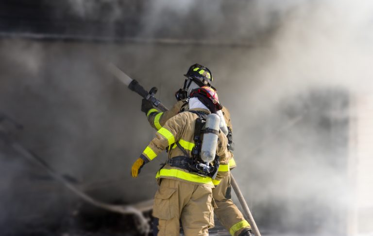 Two firefighters at work putting out a fire