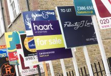 London, England, United Kingdom - February 11, 2015: FOR SALE and TO LET real estate agent sign boards outside residential housing development in Hackney.