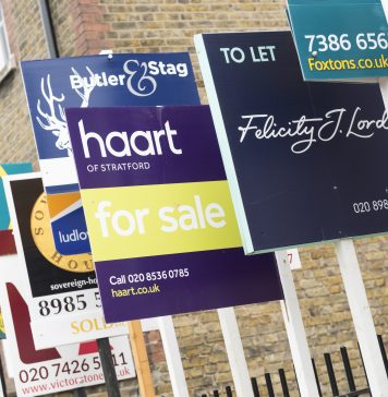 London, England, United Kingdom - February 11, 2015: FOR SALE and TO LET real estate agent sign boards outside residential housing development in Hackney.