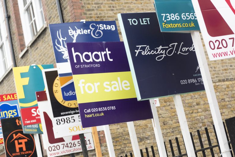 London, England, United Kingdom - February 11, 2015: FOR SALE and TO LET real estate agent sign boards outside residential housing development in Hackney.