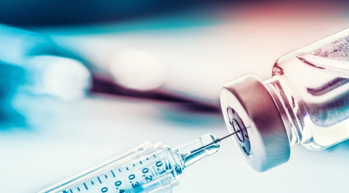 Close-up medical syringe with a vaccine, BoNT-A injection