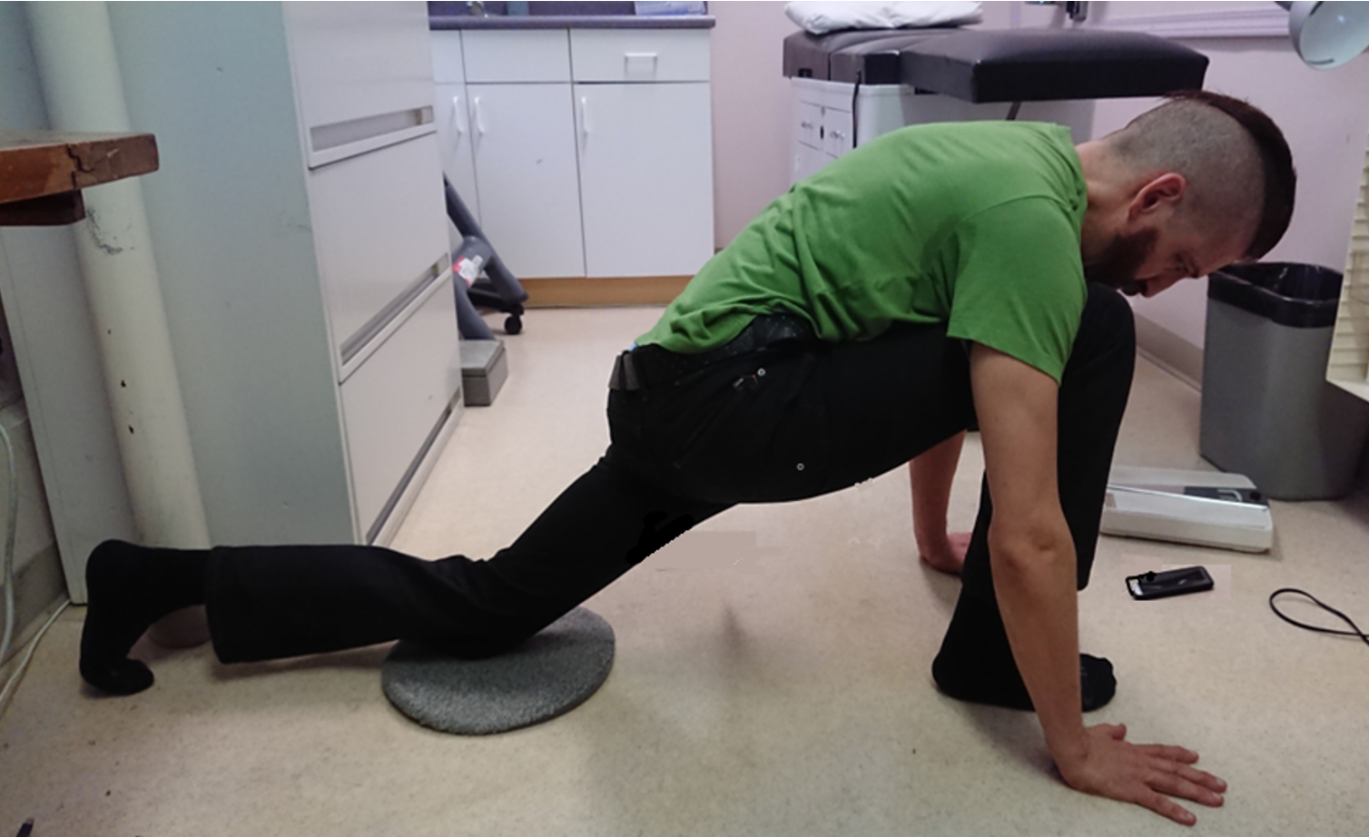 Figure 3: Man doing the corrective exercise to reposition a higher PSIS on the right and a lower PSIS on the left.