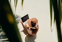 Woman freelancer on the beach in tropics