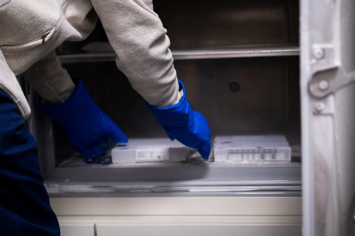 Vaccine Being Removed from a medical Fridge