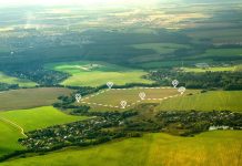 Aerial view of green field, position point and boundary line to show location and area. A tract of land for owned, sale, development, rent, buy or investment.