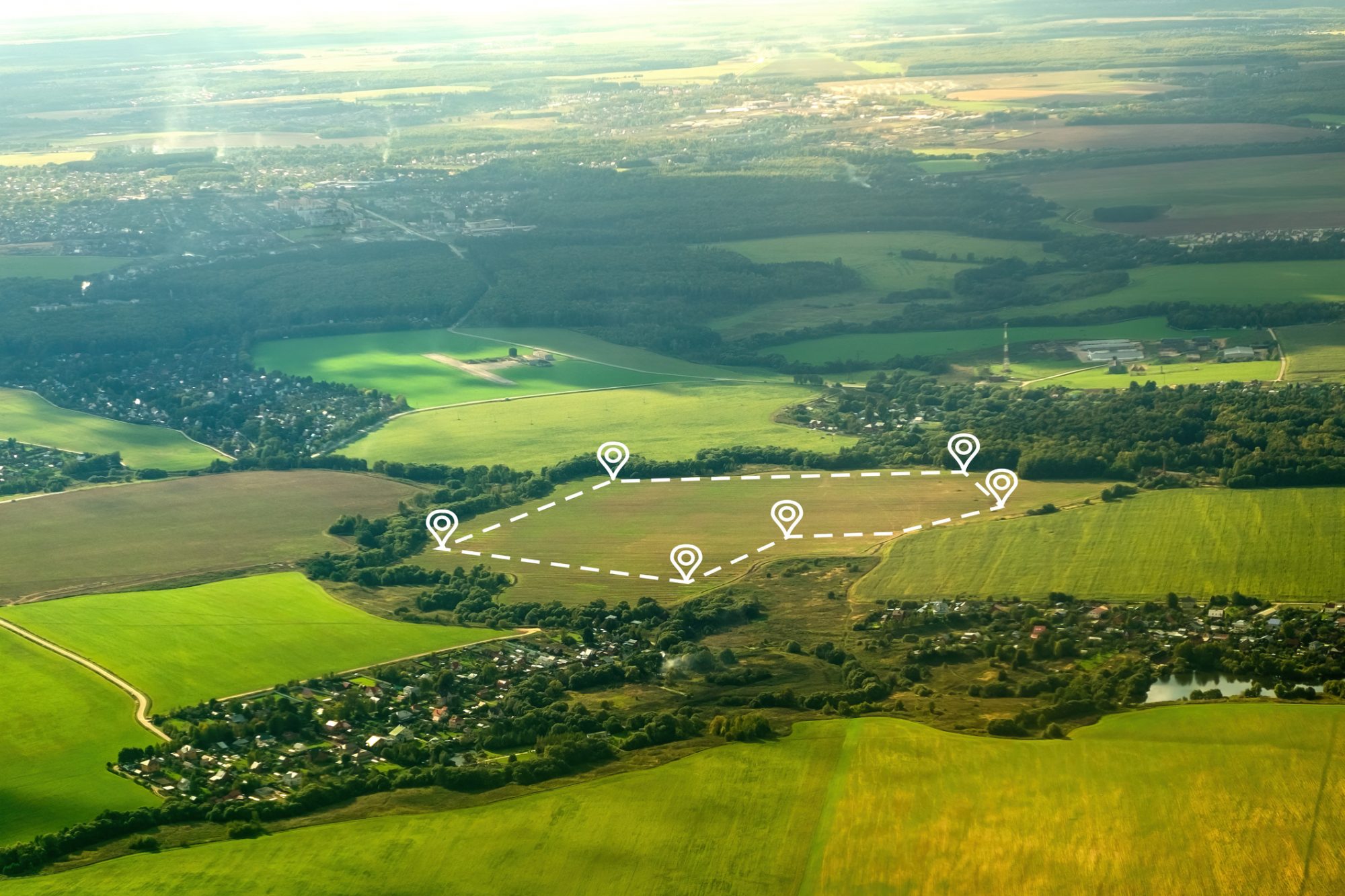 Aerial view of green field, position point and boundary line to show location and area. A tract of land for owned, sale, development, rent, buy or investment.