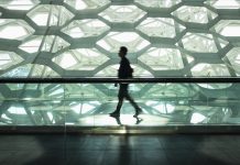 Man walking alone in modern corridor hallway. life