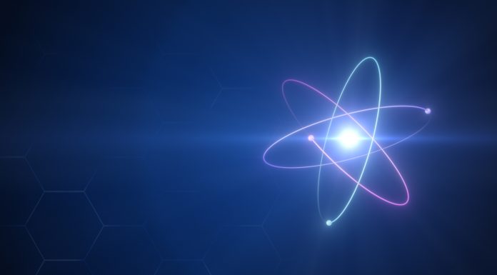 Unstable Atom nucleus with electrons spinning around it technology background