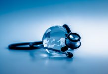 Global healthcare. Globe and stethoscope, studio shot.blue toned images.