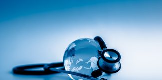 Global healthcare. Globe and stethoscope, studio shot.blue toned images.