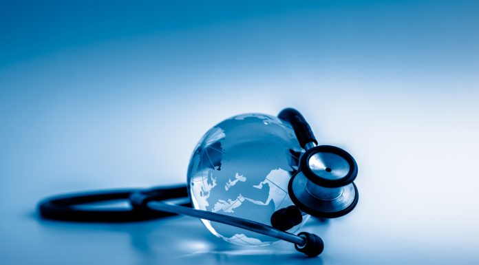 Global healthcare. Globe and stethoscope, studio shot.blue toned images.