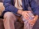 A selective of male hands holding a knee because of osteoarthritis, arthritis, and rheumatism