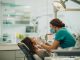 Female dentist examining young woman's teeth.