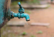 A faucet with a water drop / Water consumption concept