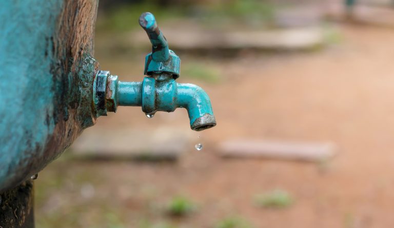 A faucet with a water drop / Water consumption concept