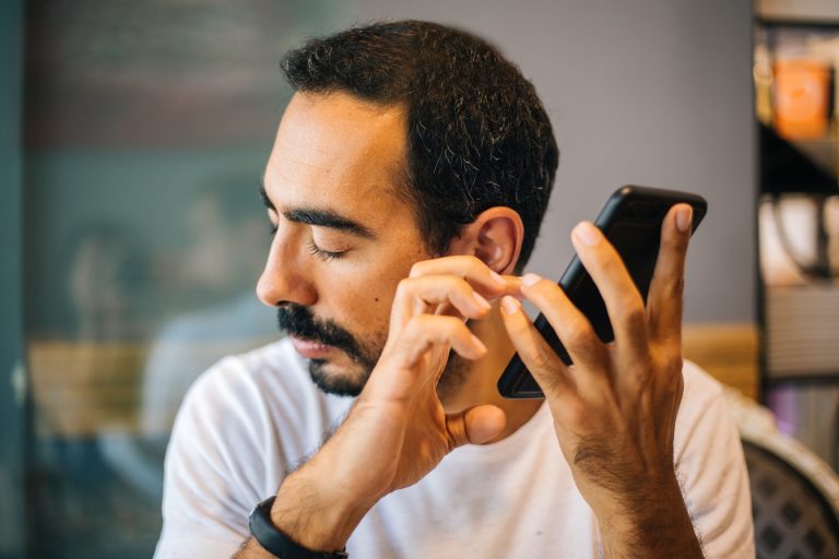 Blind man using technology