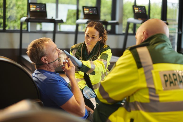 paramedic at scene with older man