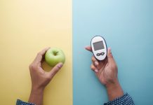 holding diabetic measurement tools, apple on table .