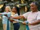 African American mature man practicing with power band on exercise class in nature.