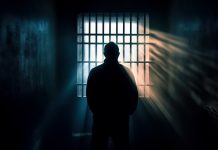 Hacker in prison cell. Selective focus. AI generated