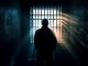 Hacker in prison cell. Selective focus. AI generated