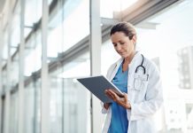 Cropped shot of a female doctor using a digital tablet