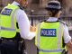 31st August, 2019 - Male and female Asian metropolitan police officers patrol the crowds of tourists outside the Hoses of Parliament in Westminster, London, UK