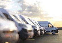 Generic row of new vans in a parking bay ready for purchase 3d render