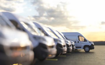 Generic row of new vans in a parking bay ready for purchase 3d render