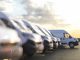 Generic row of new vans in a parking bay ready for purchase 3d render