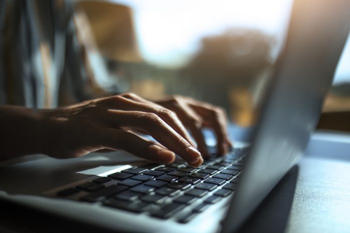 Close up of a hands on a laptop keyboard