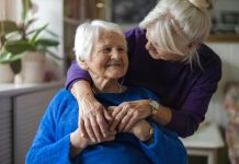 Woman hugging her elderly mother