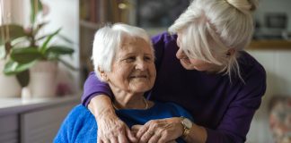 Woman hugging her elderly mother