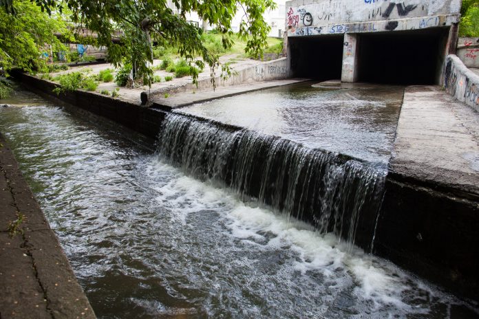 Water stream flowing out from underground tunnel