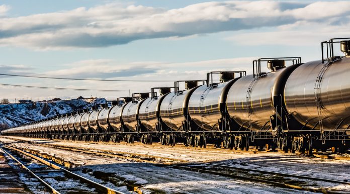 A very long oil train passing through a railyard in Havre, Montana, transporting fossil fuel from the oil fields of Williston, North Dakota. High resolution color photograph with copy space for your message. Horizontal composition.