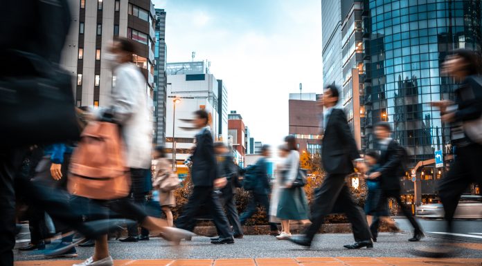 Crowd of business people on their way from work. They are unrecognisable. Long exposure shot.