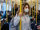 Beautiful young woman riding on the metro wearing a facemask to avoid an infectious disease - COVID-19 lifestyle concepts