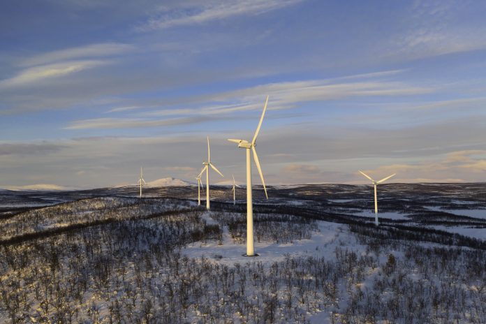 Wind power stations in a winter landscape in the Lapland province in north of Sweden above the polar circle.